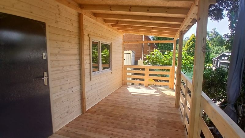 Przestronny taras pod długim zadaszeniem - realizacja Pan Domek